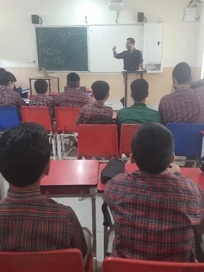 Students listen attentively during a cybersecurity workshop. Our programs are designed to be engaging and informative, covering critical topics in online security.