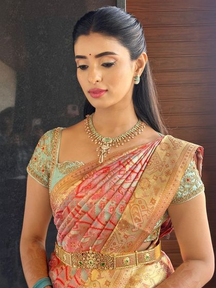 The lovely Rachna in a custom-made hand-embroidered blouse for her pre-wedding ceremony, paired with a multi-toned silk saree.