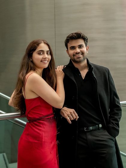 A relaxed and happy portrait on a modern staircase. The couple's genuine smiles and comfortable pose showcase their easy chemistry during their London engagement session.