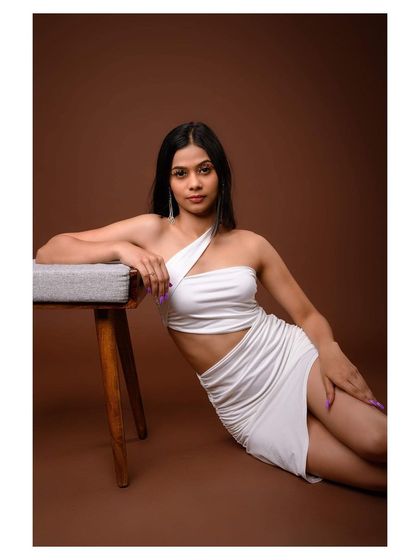 A modern and chic studio portrait. The model's pose and the clean background create a sophisticated image, perfect for a contemporary fashion portfolio.