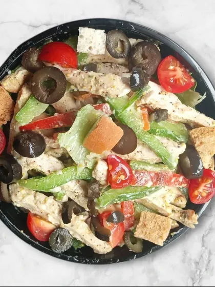 A top-down view of one of my chicken salads, showcasing the mix of fresh lettuce, cherry tomatoes, bell peppers, olives, and croutons. Every bite is full of flavor and texture.