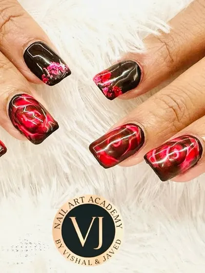 This design features a dramatic black and red marble effect, creating a look that is both luxurious and edgy. We hand-paint each swirl to achieve a unique, smoky pattern, making it a popular choice for clients who want their nails to stand out.