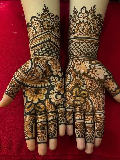 A bold and beautiful floral mehndi for the Sawan season. This design uses negative space to make the large flower and leaf motifs pop, covering the hands in a rich pattern.