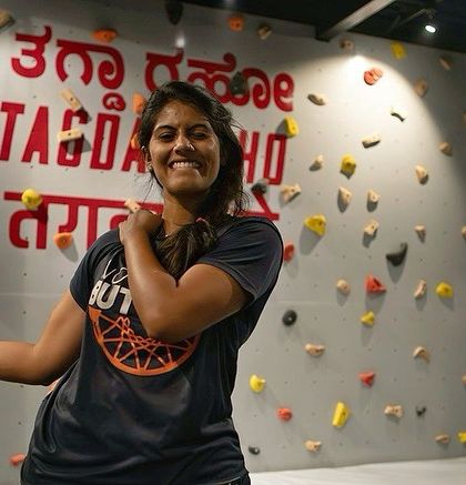 A member flexes with a huge smile in front of our brand wall. This picture is pure joy and confidence, embodying the positive spirit of the Tagda Tribe.