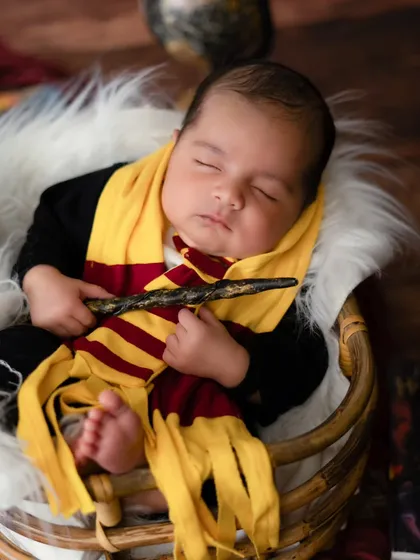 The newest student at Hogwarts. This Harry Potter themed newborn shoot was so much fun to create, complete with a Gryffindor scarf and a magic wand.
