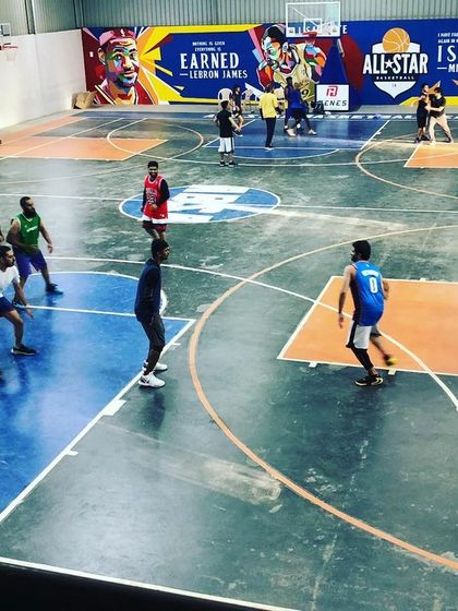 Players spread out during a fast-paced game. The clear markings for the key and three-point line make our court ideal for structured basketball play.