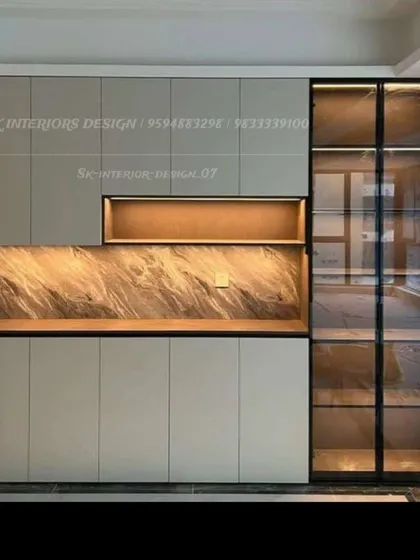 This custom storage unit combines closed cabinets, an open display niche with a marble-textured back, and a tall glass-fronted cabinet for a balanced and functional design.