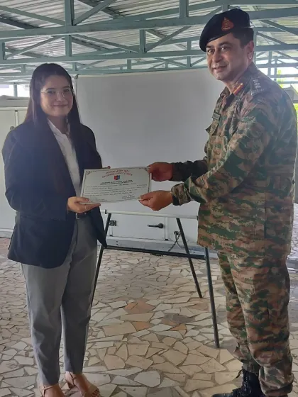 Receiving a certificate of appreciation from an NCC officer for my contribution.
