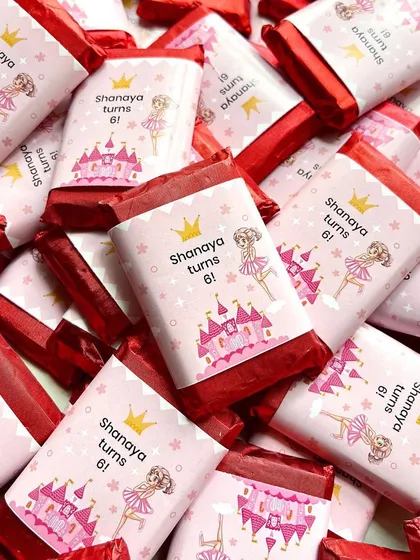 Custom mini chocolate bars made for little Shanaya's 6th birthday party. The princess-themed wrappers add a magical touch to these sweet party favors.