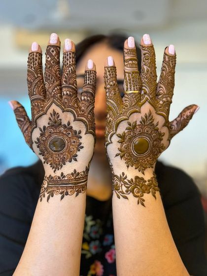 A client showing off her beautiful mandala designs, which feature a different pattern on each wrist.