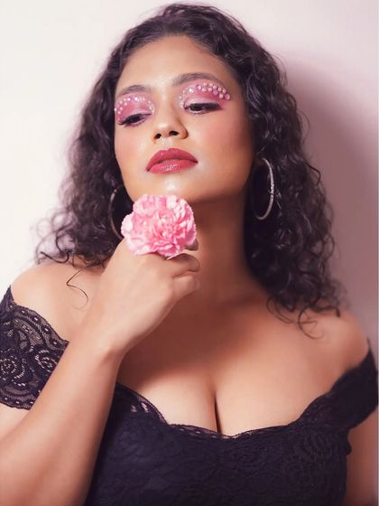 A slightly different angle of the pearl makeup look, showing how it catches the light. The combination of a bold lip and creative eyes makes for a memorable image.