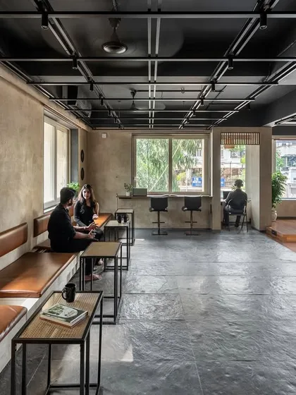 The café serves as the social heart of the 'Chasing Tales' creative incubator, designed to foster interaction and visual connectivity. We positioned it at the entrance to welcome visitors and create a seamless flow between the public social space and the more private work zones within.