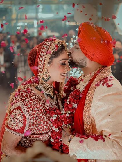 A magical moment under a shower of rose petals. This is the kind of picture-perfect memory I help create with my makeup.