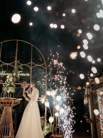 A truly magical moment. We framed the couple's reception with a custom arch and sparklers against the backdrop of a serene lake, creating an unforgettable 'Always & Forever' memory.