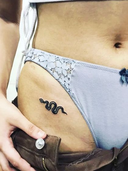 The finished minimalist snake tattoo.