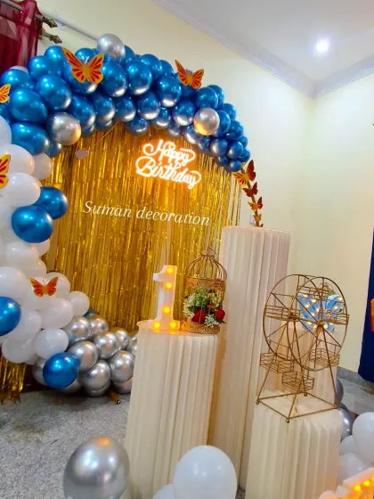 A detailed view of the props and marquee number '1' used in the blue butterfly-themed birthday decoration.