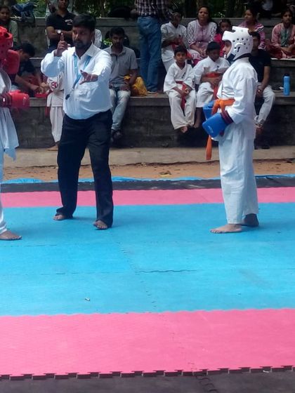The referee signals the start of the match. The fighters are focused and ready.