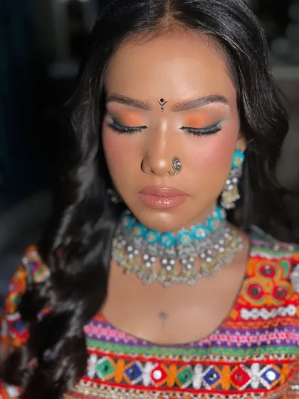 A close up of the Navratri eye makeup. We used a bright orange eyeshadow with sharp winged liner and full lashes for a dramatic and festive effect.