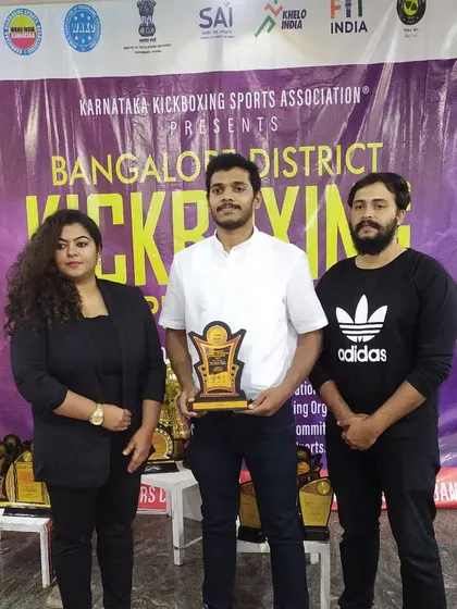 Receiving a token of appreciation for judging at the Bangalore District Kickboxing Championship. I enjoy sharing my knowledge and experience with the next generation.
