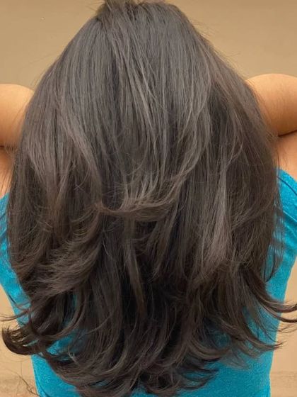 The back of a client's hair, showing the beautiful, long layers and the volume they create.