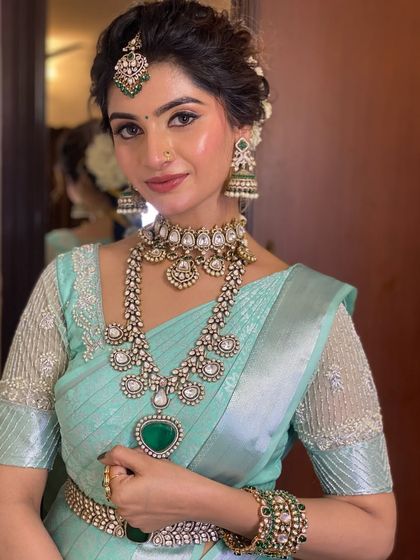 Draping for Swathi Naidu in a beautiful pastel blue saree. This look is perfect for a special occasion or function, with a soft drape that complements her elegant jewellery.