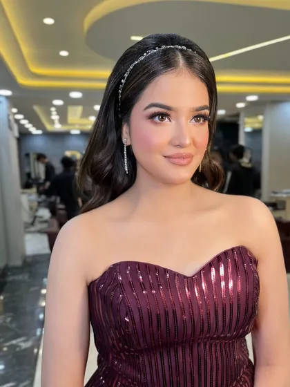 Another angle of this beautiful party look. The makeup is flawless, and the hair is styled in soft, elegant waves.