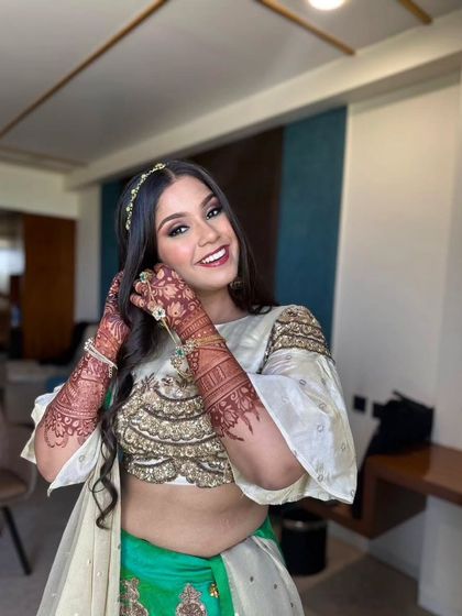 A happy and bright portrait of the bride, showing off her intricate henna and beautiful smile.