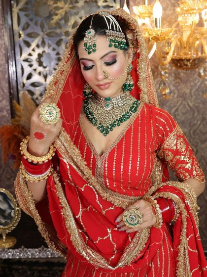 A closer look at the red gota patti lehenga and the layered emerald jewelry set.