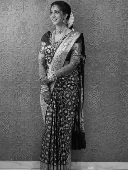 Engagement perfection in black and white. This image captures the timeless beauty of a well-draped saree, with every pleat and fold contributing to a look of pure grace.