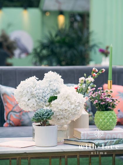 A table centerpiece from the baby shower, featuring white hydrangeas and other delicate blooms.