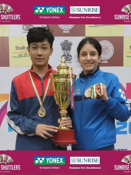 Our U-14 Boys Singles gold medalist, Martin, with his coach after a successful run at the School Games Nationals. This one-on-one guidance is crucial for individual success.
