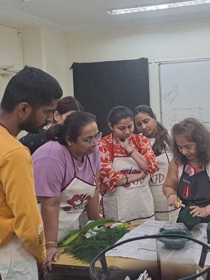 Our instructor provides a demonstration to a small, attentive group. This personalized guidance in Class 1 ensures every student understands the core techniques before starting their own design.