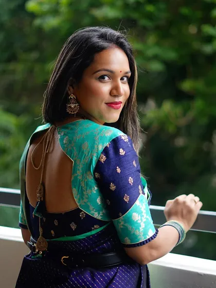 The back view of Supritha's blouse, highlighting the unique patchwork design and perfect fit.