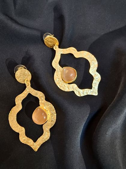 The elegance of pure brass golden stone earrings, shown up close to highlight the texture and stone quality.