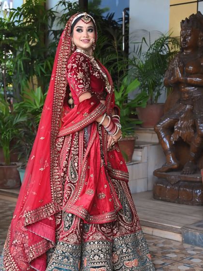 A full-length shot showing the elegance of the double dupatta style with a velvet lehenga.