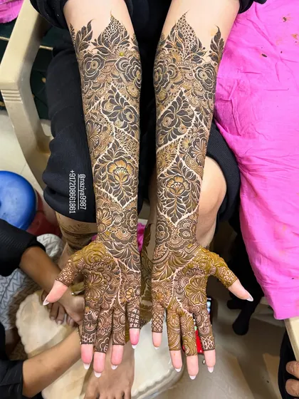 A stunning example of a Gulf-style bridal design, featuring bold floral motifs connected by intricate vine work.