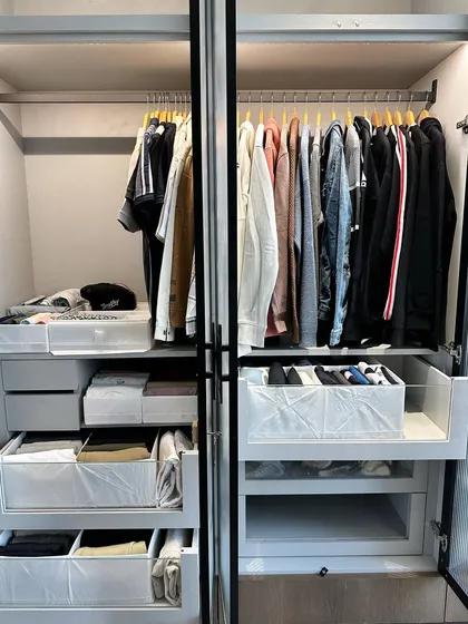 A look at a "His and Hers" wardrobe setup. We use different colored hangers to visually separate the sections, making it intuitive for the couple.