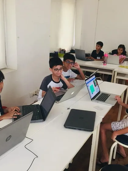 A candid shot of our classroom where young coders are busy with their projects. Our project-based curriculum keeps them focused and motivated as they learn key programming skills.