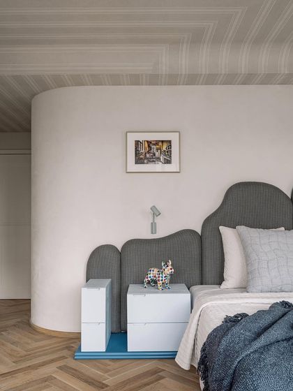 A closer look at the custom headboard and curved wall in the master bedroom. The design is all about soft lines and tranquil colors.