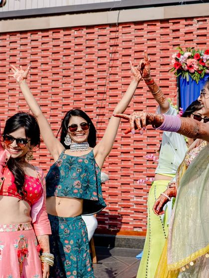 Pure joy and celebration. The bride's squad having the time of their lives during an outdoor mehendi dance performance.