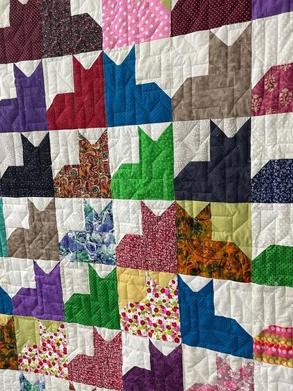 A "Cat City" quilt, featuring rows of colorful cat silhouettes. A perfect project for any feline fan!