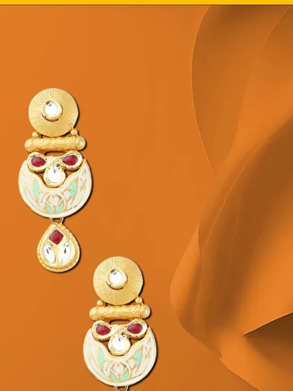 Jewels of empowerment. These contemporary earrings feature a unique crescent design with red stones and white enamel, offering a stylish and modern accessory.