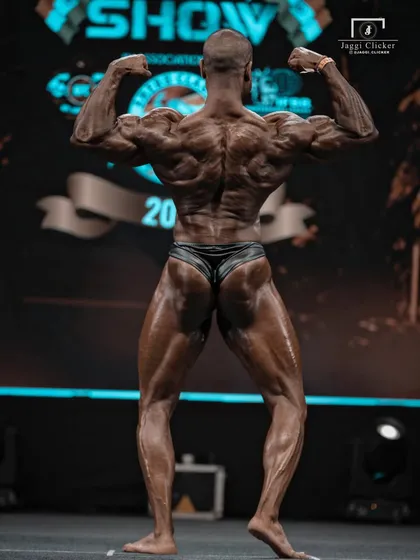 The Back Double Biceps pose. This is what wins big shows. The detail in the back, from the traps down to the glutes, is a result of relentless training and a scientific approach to prep.