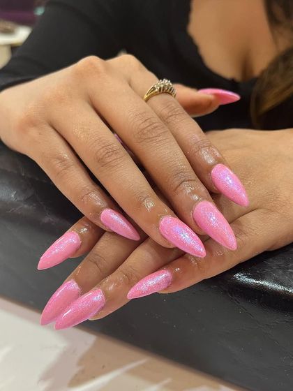 Pretty in pink with a pearly finish. These long stiletto nails are coated in a beautiful pearl gel that gives them a magical, iridescent shimmer.
