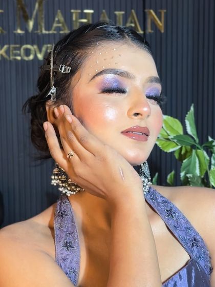 A serene shot with closed eyes, highlighting the beautiful purple eyeshadow.