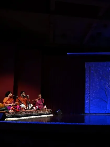 The stage is set for Stuti Mukherjee's arangetram. The live orchestra is seated and ready, their presence creating an atmosphere of anticipation and festive energy before the performance begins.