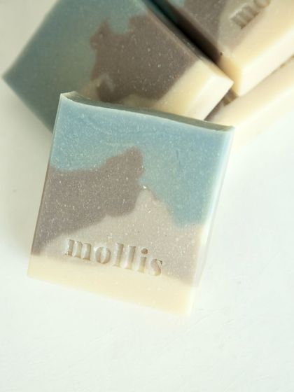 A close-up of a 'Rain Veil' bar, showcasing its smooth texture and stamped logo.