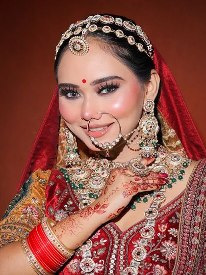A happy bride showcasing the final look. Our students learn to create makeup that not only looks stunning but also feels comfortable and lasts all day.