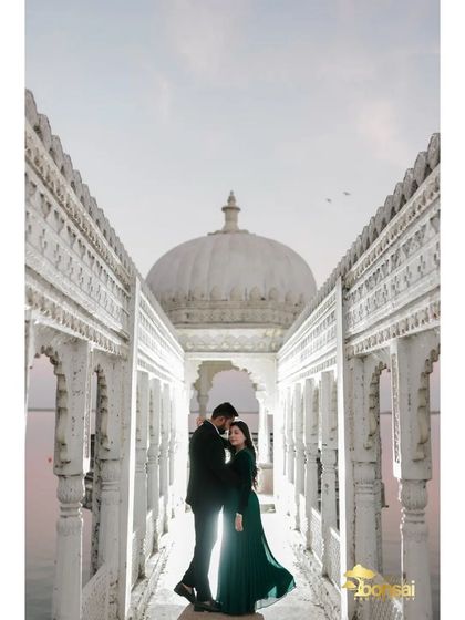 A silhouette against the stunning architecture of a waterside palace. This artistic shot creates a sense of timelessness and grandeur for this destination pre-wedding shoot.