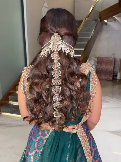 A stunning hairstyle with a traditional hair accessory. The hair and makeup work together to create a complete and polished look.